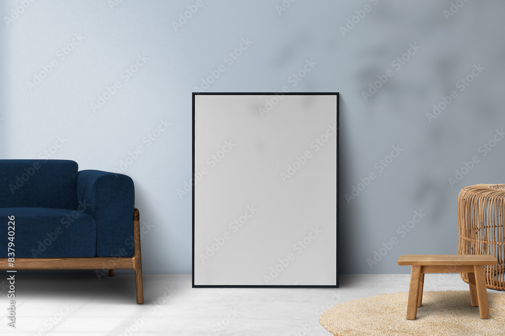 Wall mural Picture frame png mockup leaning on a blue wall in a living room