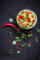 bowl guacamole tomato chilli pepper lime onion garlic dill and oregano