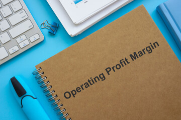 Operating profit margin documents, papers and marker.