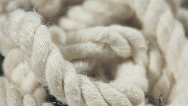 Close up of natural cotton rope. Thick cotton rope showing detail of threads and fibres, macro shot.