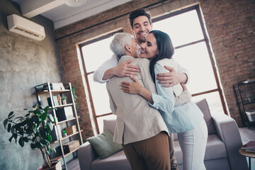 Photo of group friendly corporate coworkers embrace good mood loft interior business center indoors