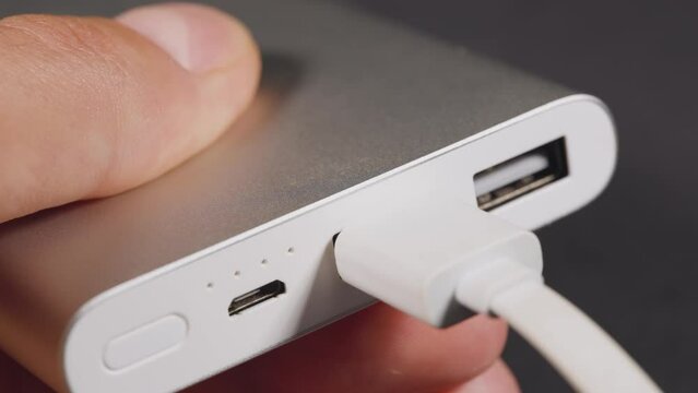 Connecting and unplugging usb type-c cable to power bank. Using powerbank station for charging devices via modern fast usb c port.