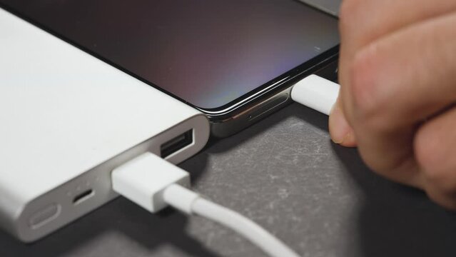 Charging smartphone with power bank.