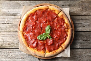 Tasty pepperoni pizza on wooden table, top view