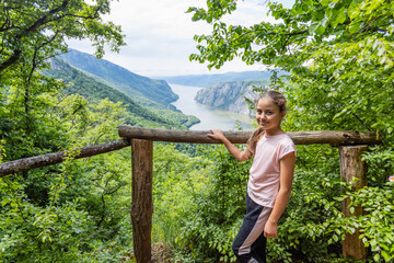  Happy Child At The Breathtaking View Of The Danube River Gorge. Surrounded By Lush Greenery, The...
