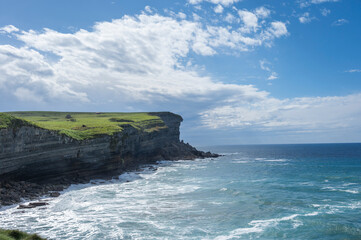 Coastal Seascape with Prominent Cliff and Ocean Waves: A Naturalistic Style Photograph