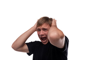 Fototapeta premium Talking Caucasian blond 16 year old guy dressed in a black T-shirt