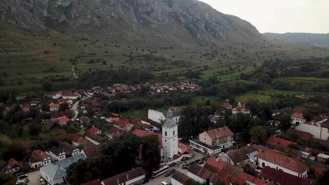Detailed drone shot of the Rimetea, Torocko church in Romania. Drone is turning above the roof the church.