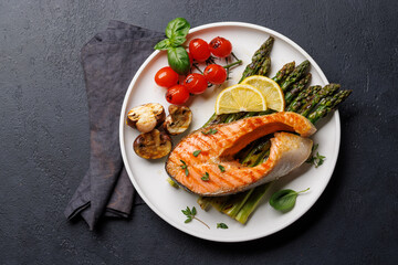 Grilled salmon steak over grilled asparagus, a delicious and healthy meal