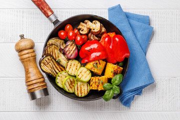 Assorted grilled vegetables on a frying pan, showcasing a colorful and healthy meal