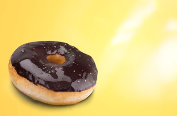Sweet tasty chocolate donut on the desk