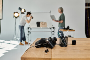 Two middle-aged women, collaborating on a creative project in a professional photo studio setting.