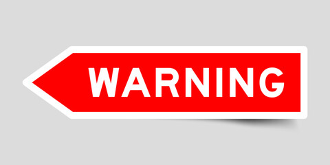 Red color arrow shape sticker label with word warning on gray background