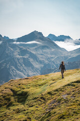 Obraz premium Young Woman With A Backpack on The Top Of a Beautiful wild Landscape. High quality photo