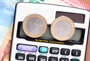 1 euro coin on the screen of the calculator. Concept for business.