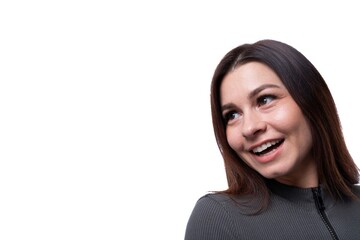 Fototapeta premium 25 year old woman with black hair smiling sweetly, close-up photo on a white background with copy space