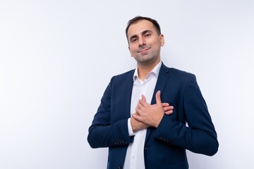 A 40-year-old successful brunette man dressed in a blue jacket is proud of himself