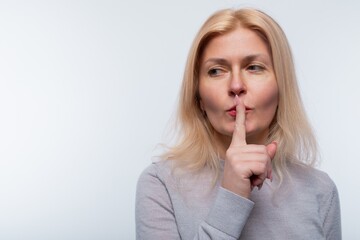 Naklejka premium European woman with blonde hair keeps a secret