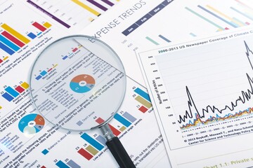 Magnifying glass on paper document with graph