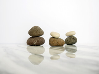 Zen basalt stone on white marble background