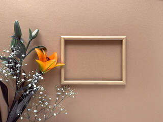 Minimalist Floral Composition with Wooden Frame on Brown Background.