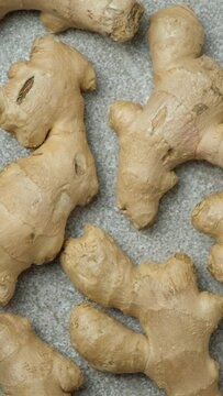 Fresh ginger roots spinning close-up top view vertical shooting