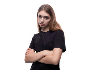 A cute fair-haired teenage girl in a black T-shirt is thinking