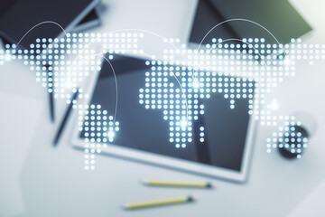 Abstract creative world map with connections and modern digital tablet on background, top view, international trading concept. Multiexposure