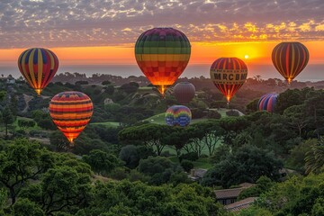 Obraz premium Colorful Hot Air Balloons Soaring Over Green Hills at Sunrise