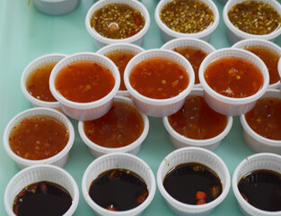 spicy sauces on table