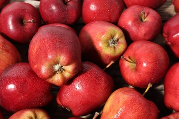 Many fresh apples with water drops as background, above view