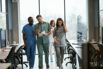 Walking together. Group of doctors are indoors