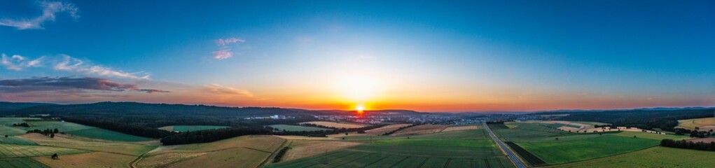 Bird's eye view of fields and meadows in the Taunus in summer at sunset