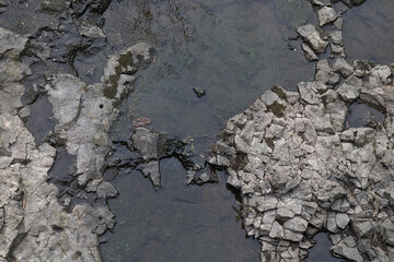 Slowly moving water contrasting with dry rocks
