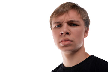 Obraz premium Close-up portrait of a blond 16 year old guy dressed in a black T-shirt against a background with copy space