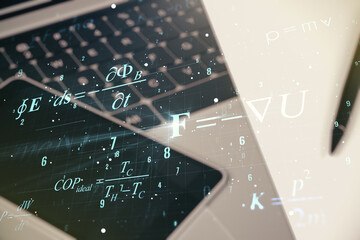 Creative scientific formula concept on modern laptop background. Multiexposure