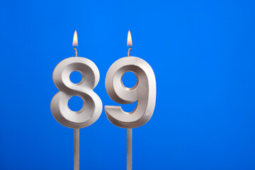 Birthday number 89 - Candle lit on blue background