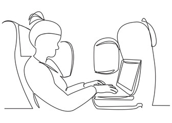 business woman in the airplane behind the laptop