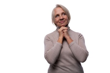 Pensioner woman with gray hair feels confident on white background with copy space