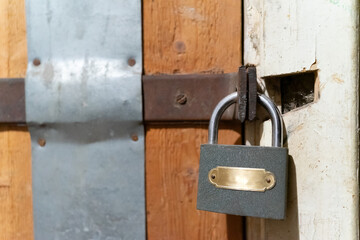 A closed wooden door with a small metal lock