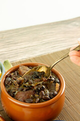 Brazilian Feijoada Food black bean stew with bacon and pork sausage ceramic bowl