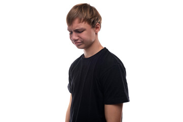 Puzzled European teenage boy with blond hair on white background