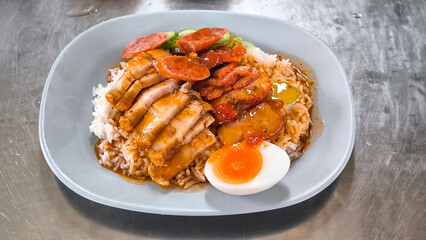 Crispy pork rice on a blue plate on the dining table
