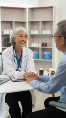 Fototapeta premium Asian female doctor and patient talking about something while sitting at the table, female doctor wearing white uniform and a stethoscope is checking the condition of an elderly male patient.
