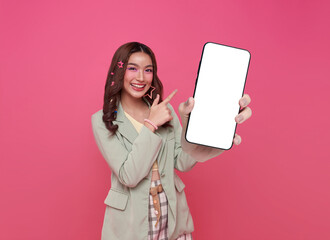 Beautiful Asian woman showing and pointing finger to smartphone mockup of blank screen isolated on...