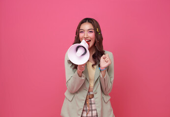 Young Asian teen woman holding megaphone announce discount isolated on pink copy space background....