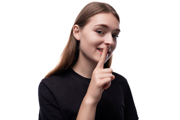Cute sly fair-haired teenage girl in a black T-shirt