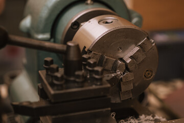 Front view of a set of various tools placed on a wooden desk in a workshop