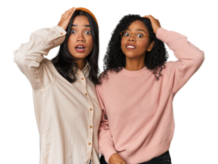 Young Latin friends together in studio being shocked, she has remembered important meeting.