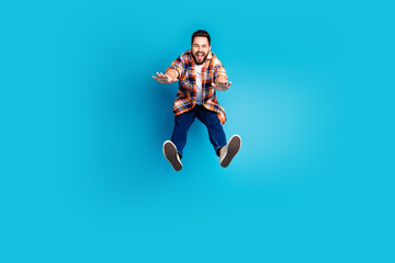 Fototapeta premium Full size photo of nice young man jump fall wear shirt isolated on blue color background